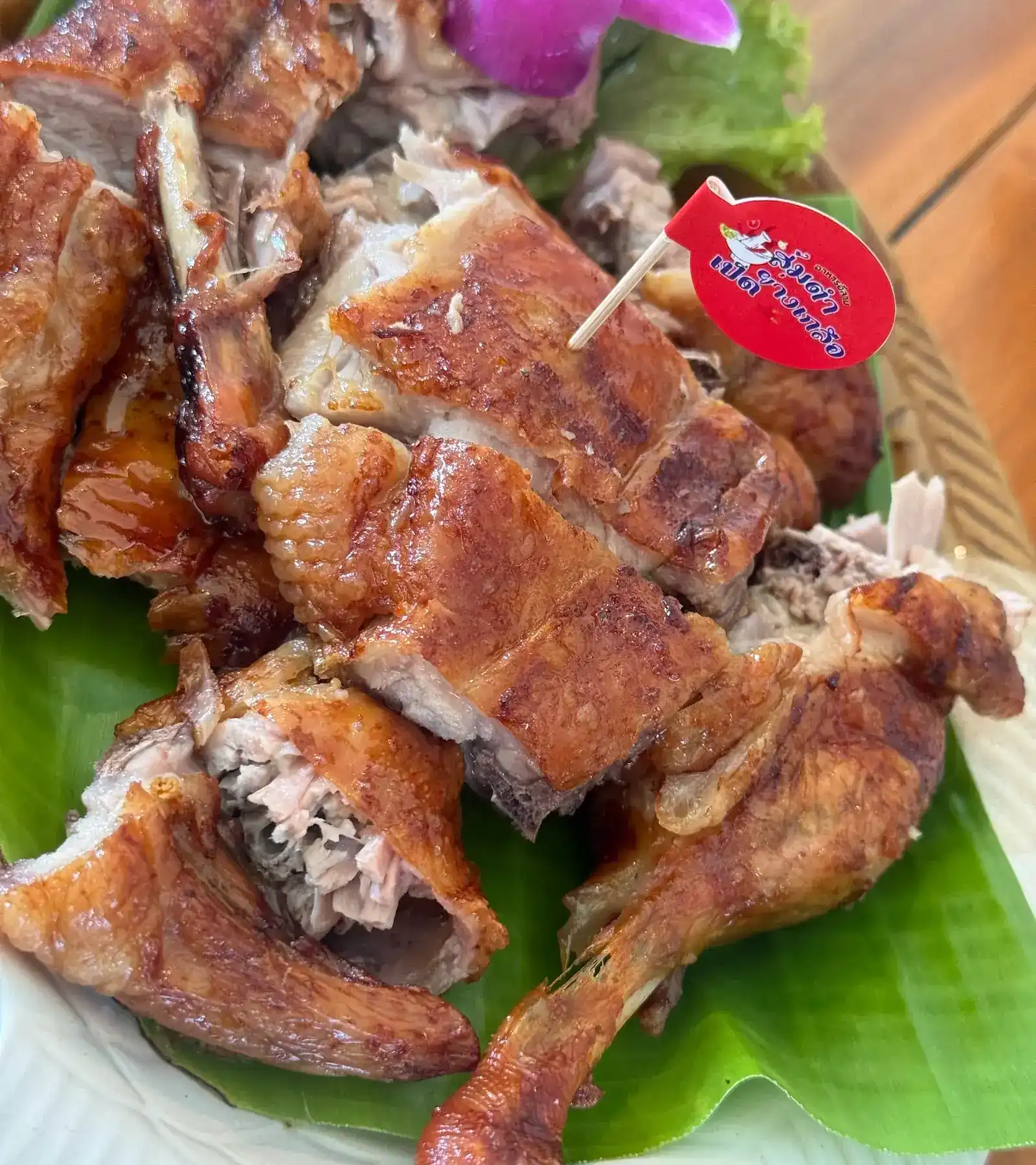 Salt-roasted duck on banana leaf, with the restaurant's red flag pick