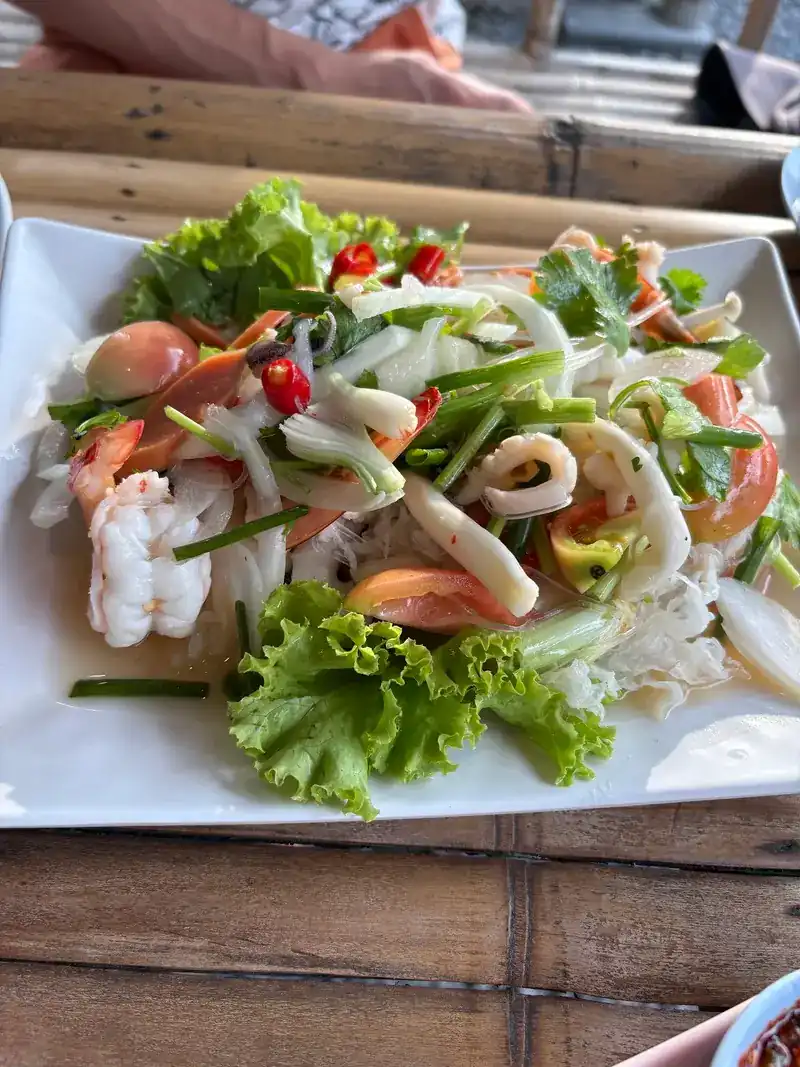 Seafood salad with squid, prawns, celery and tomato