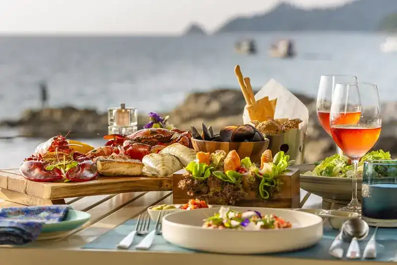 Seafood platter with lobster, crab, mussels and salads on a table by the sea