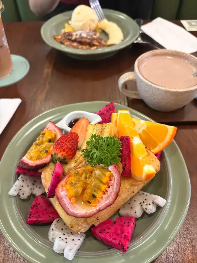 Toast heaped with passion fruit, dragon fruit, strawberry and orange