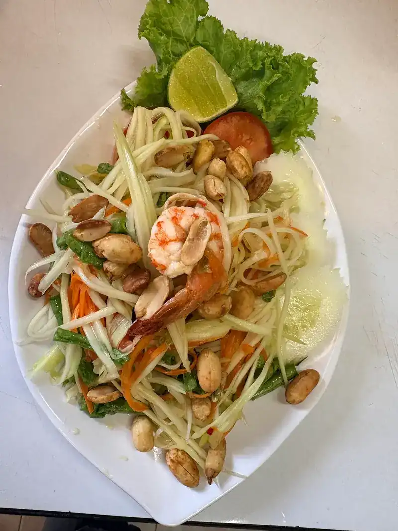 Green papaya salad with a prawn, peanuts, lime and tomato
