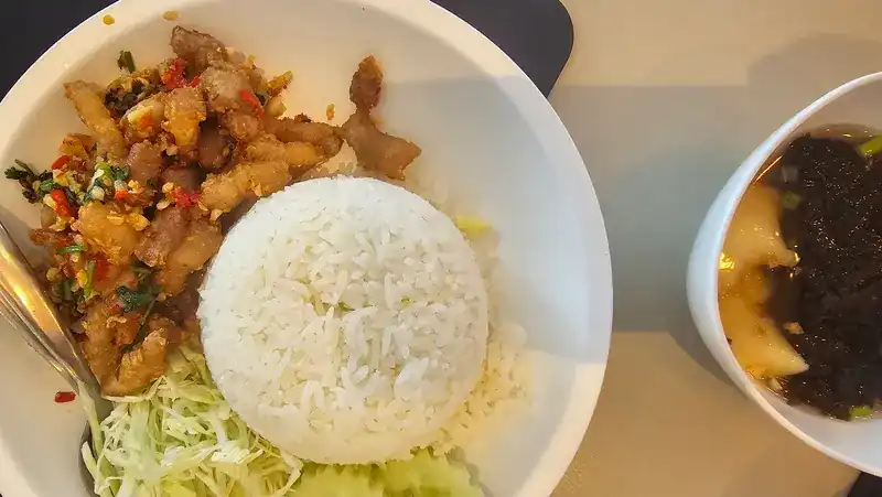 Crispy pork with chilli and garlic over rice, with a bowl of soup