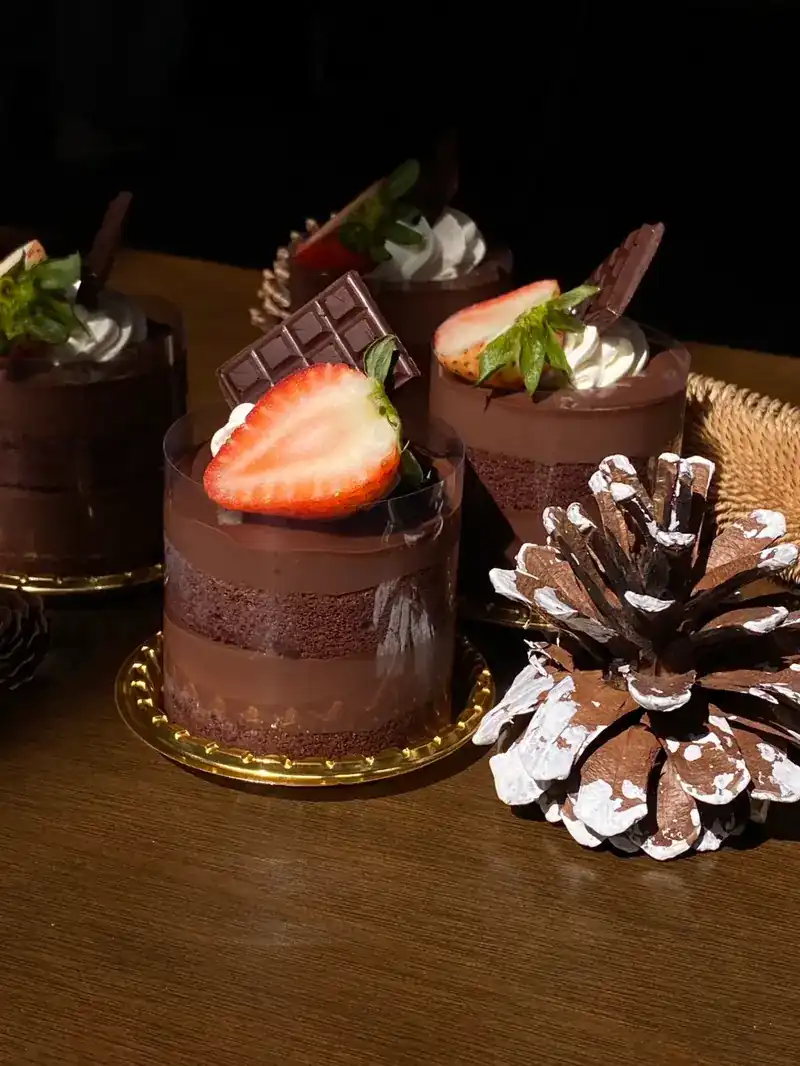 Layered chocolate cakes topped with strawberries