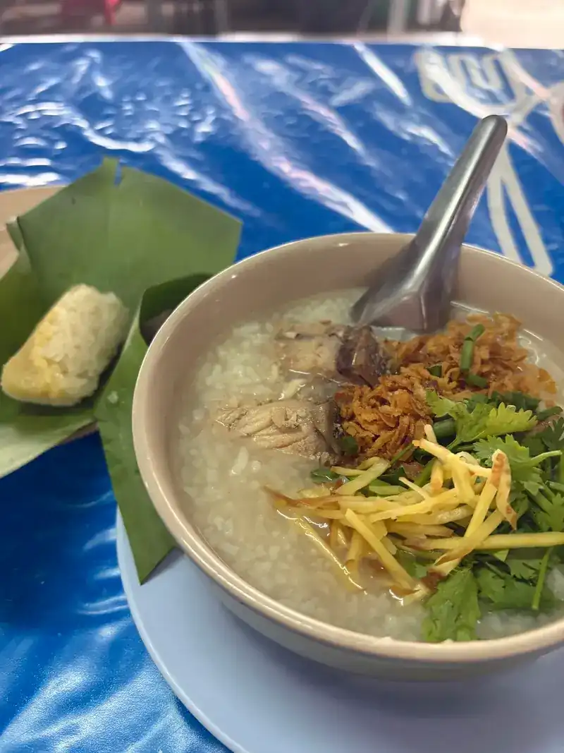 Rice soup topped with shredded ginger, coriander and crispy shallots