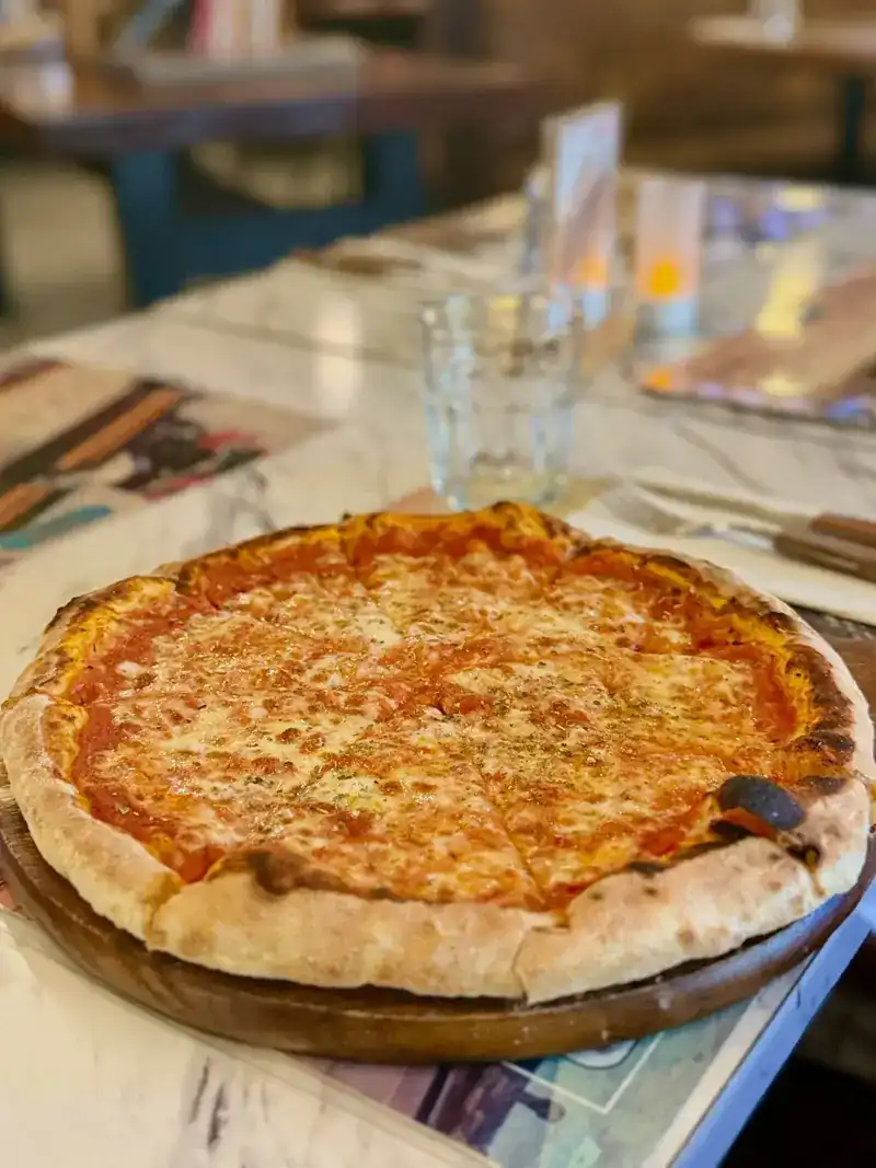 Cheese and tomato pizza on a wooden board