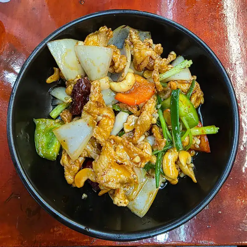 A stir-fry with cashew nuts, onion, peppers and spring onion