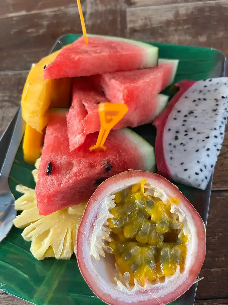 A fruit plate of watermelon, dragon fruit, passion fruit and pineapple
