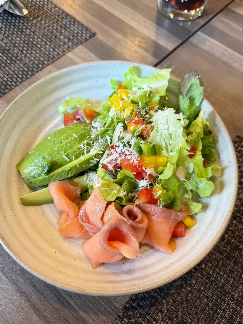 Smoked salmon and avocado salad with mixed leaves and diced peppers