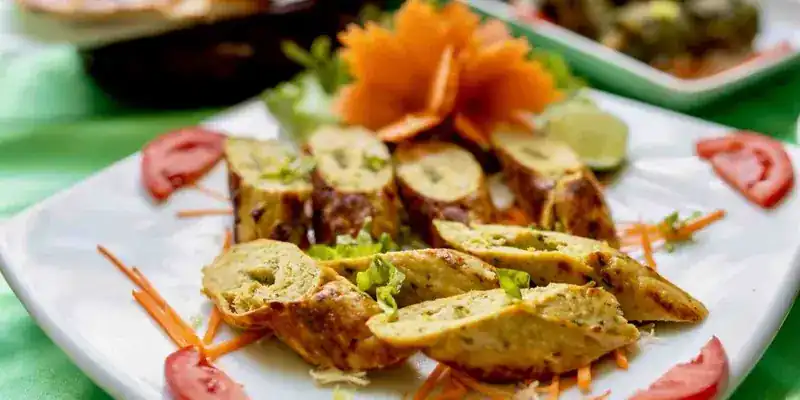Chicken sheesh kebab, sliced, with carved carrot