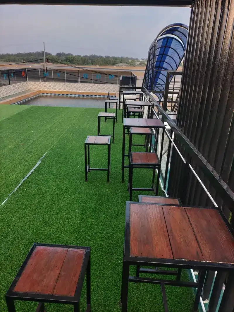 High tables and stools along the rail on the rooftop