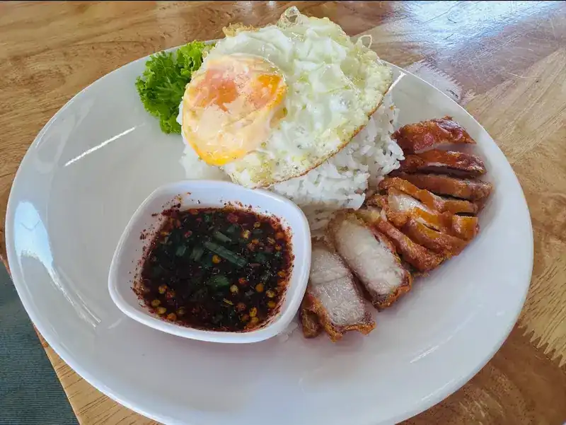 Rice with fried pork, a fried egg and a chilli dip