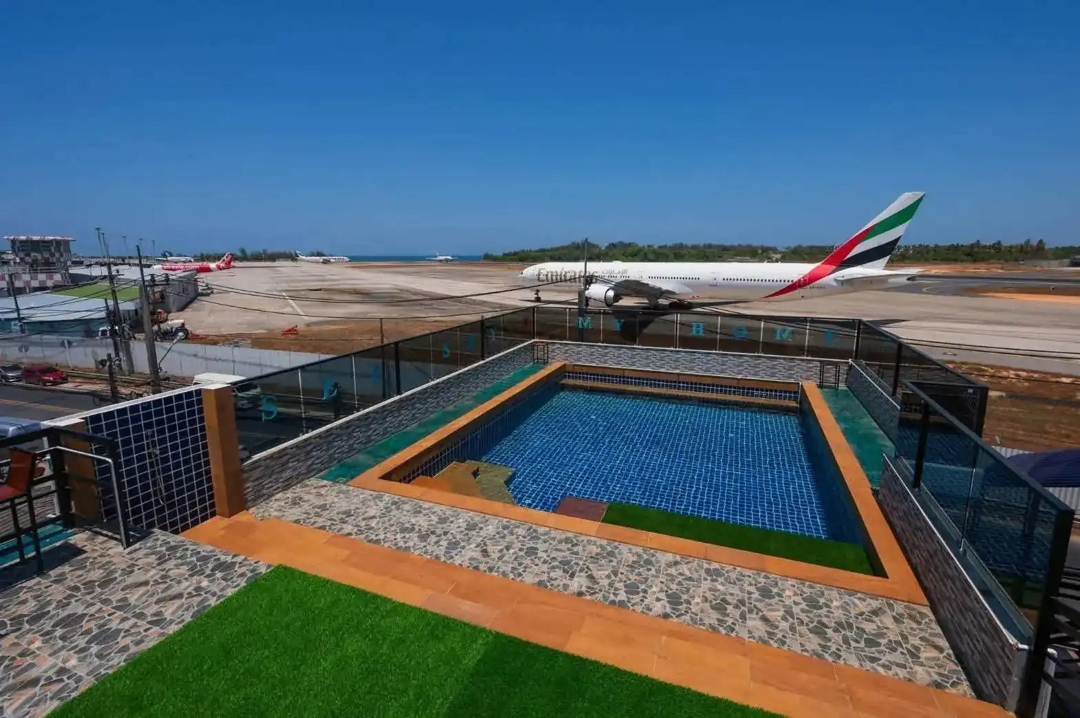 The rooftop pool at Sea Sky Café, with a passenger jet on the airfield across the road