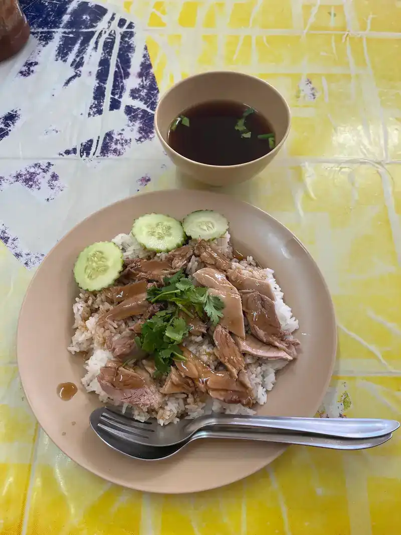 Duck on rice with cucumber, and a small cup of broth