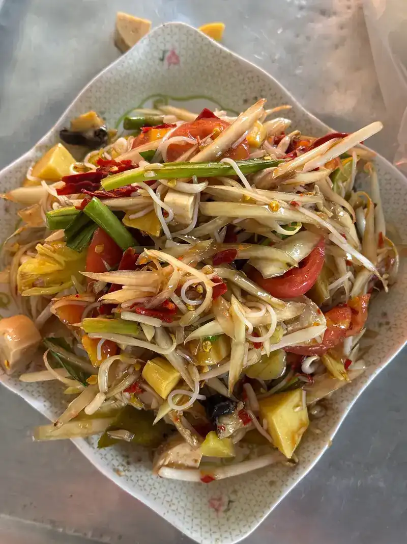 Papaya salad tossed with thin rice noodles