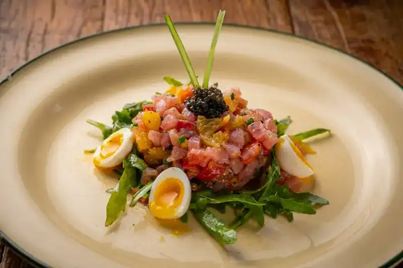 Tuna tartare topped with caviar, quail eggs and rocket