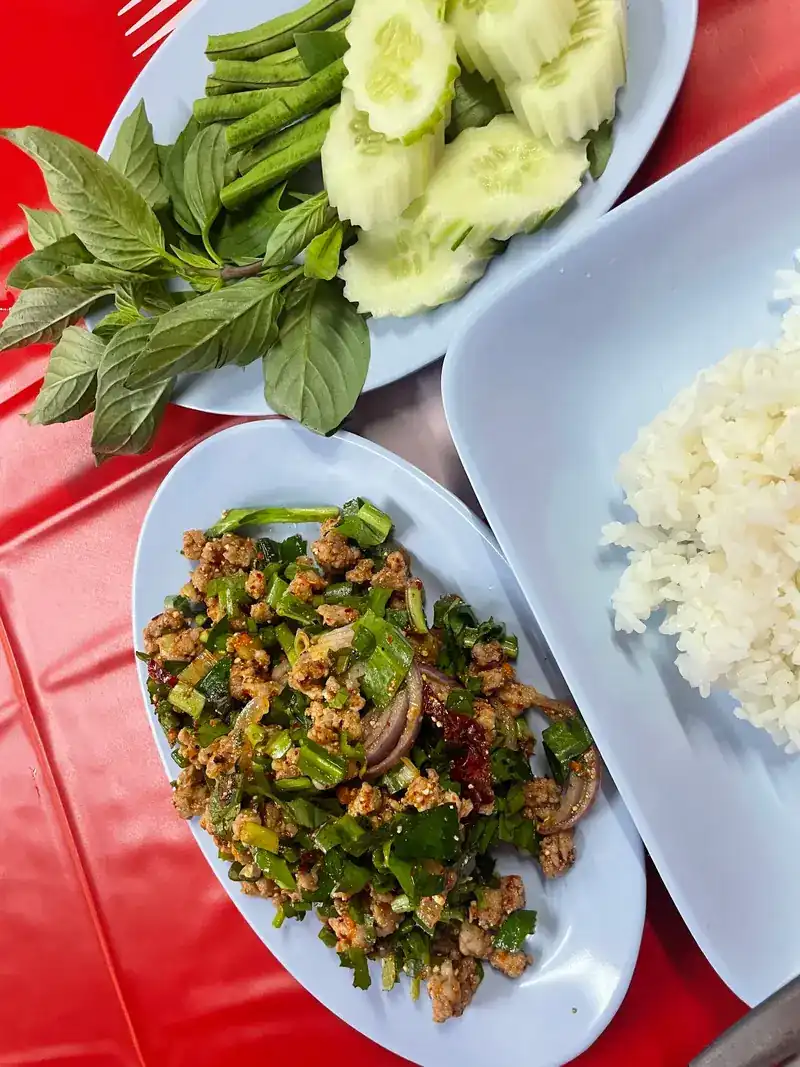 Larb with steamed rice, fresh herbs, cucumber and long beans