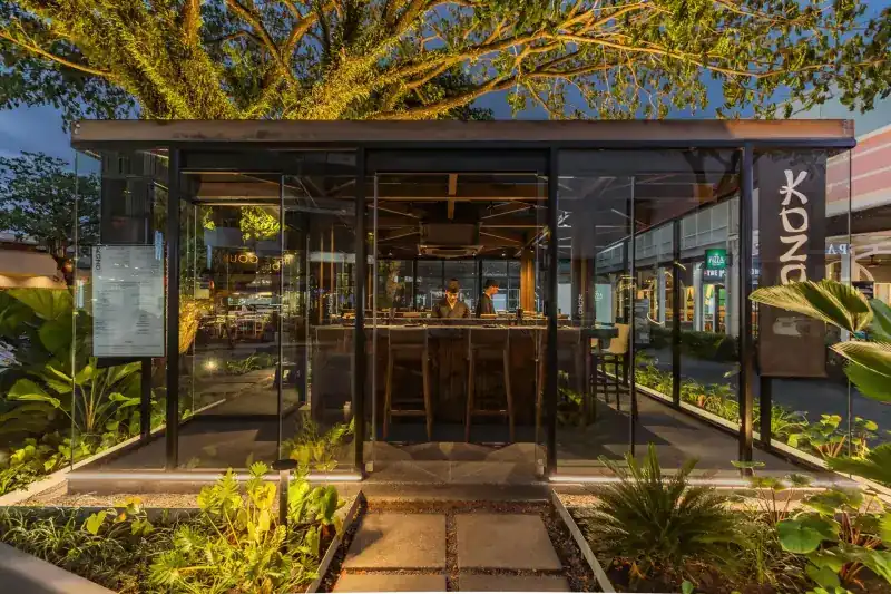 The glass pavilion on Boat Avenue at dusk, its counter seen through the glass