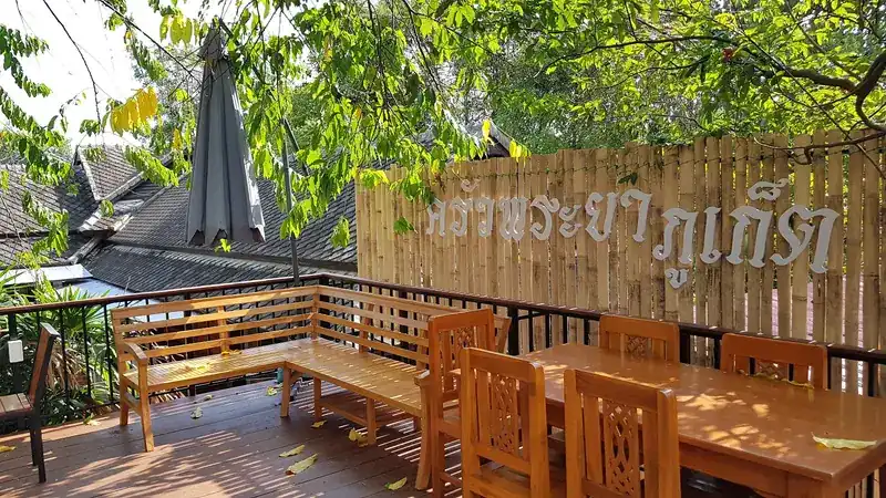 The raised wooden deck beside the bamboo fence with the restaurant's name