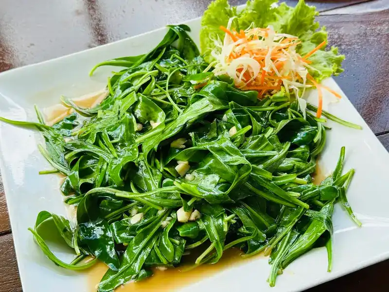 A plate of stir-fried greens with garlic