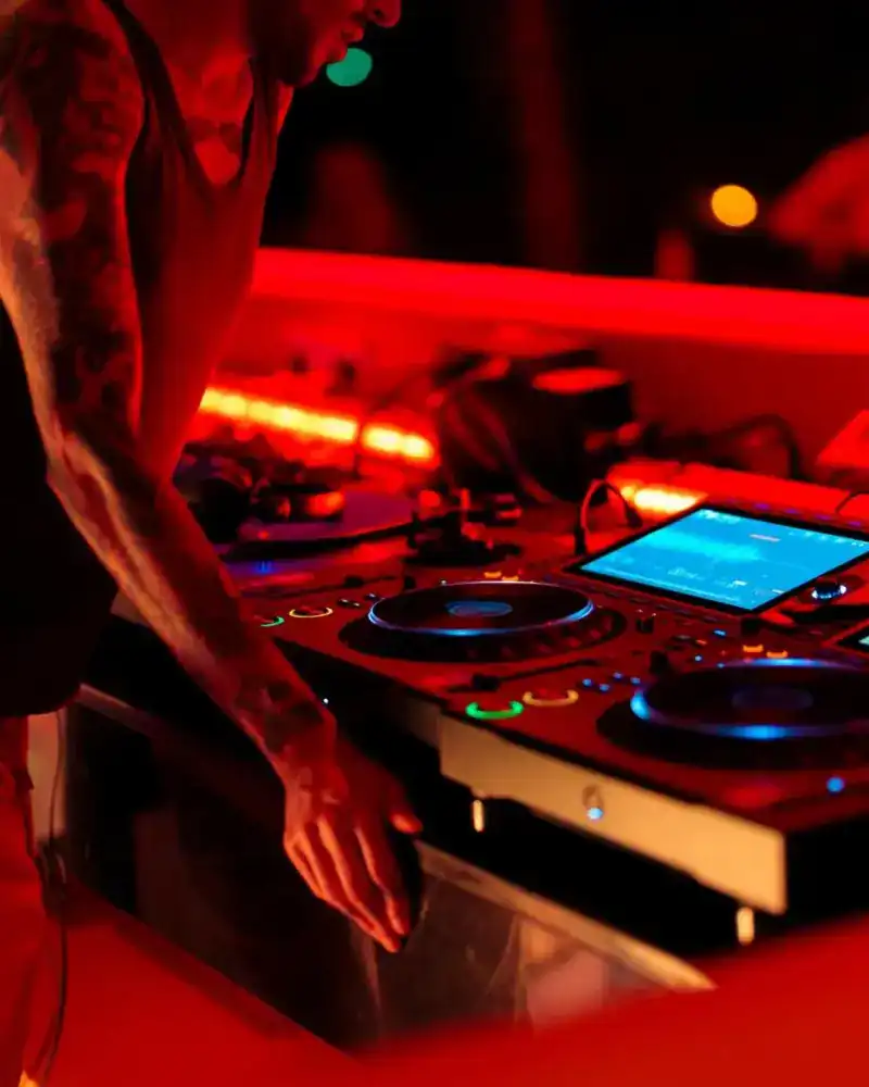 Hands on the decks under red light