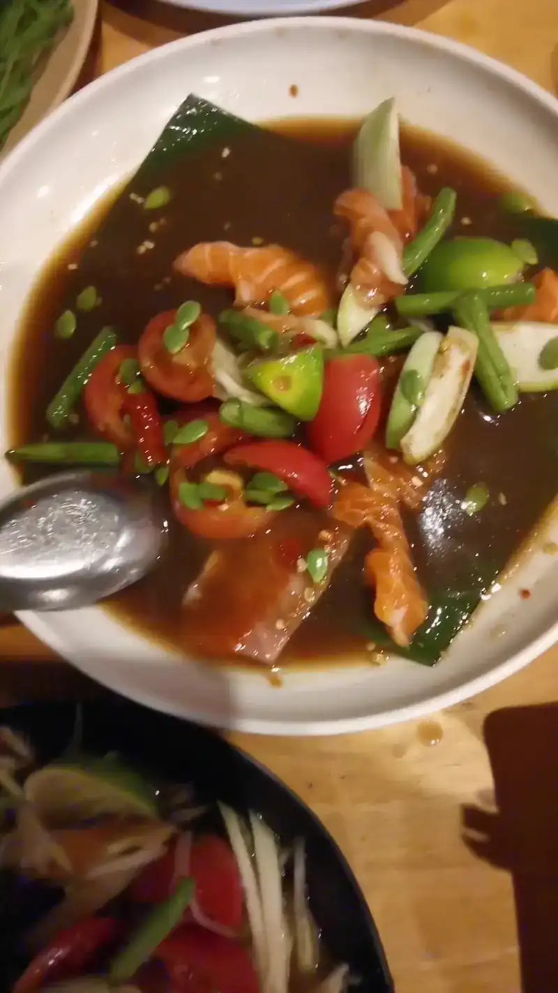 Sliced salmon with tomato and lime in a spicy dressing