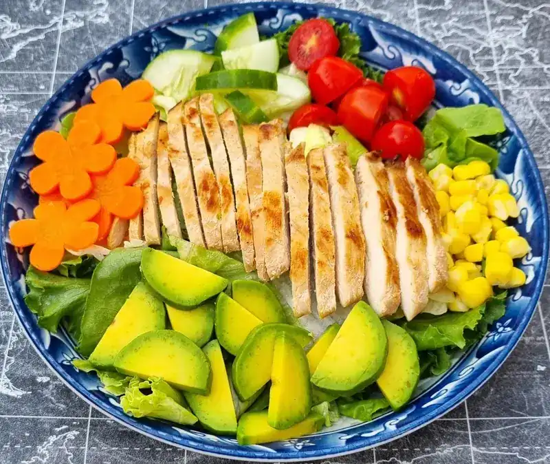 Grilled chicken salad with avocado, corn and tomatoes