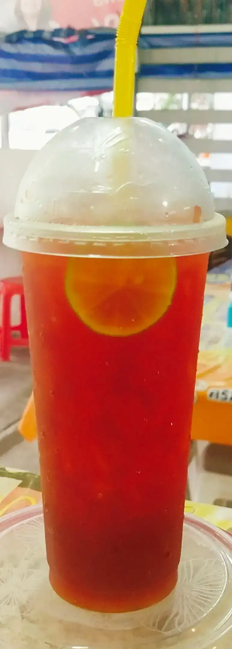 Iced tea with a slice of lemon in a tall cup