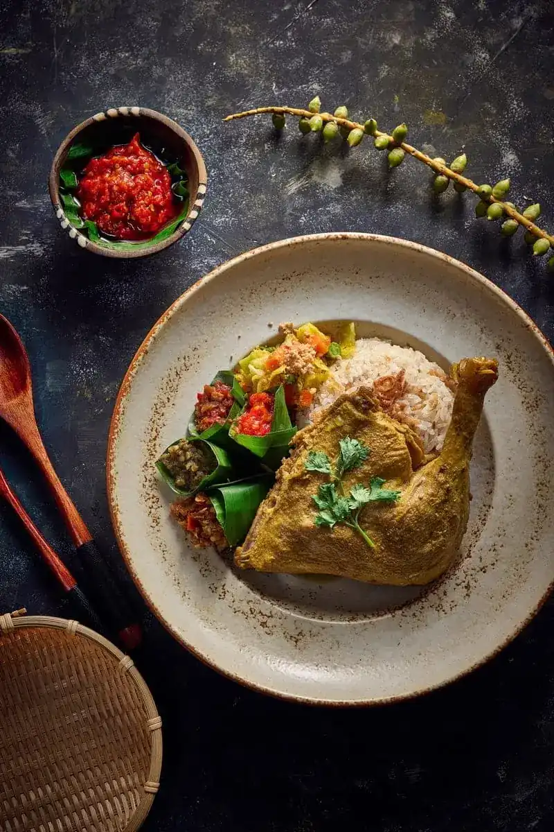 Ayam Betutu, spiced chicken leg with rice and sambal