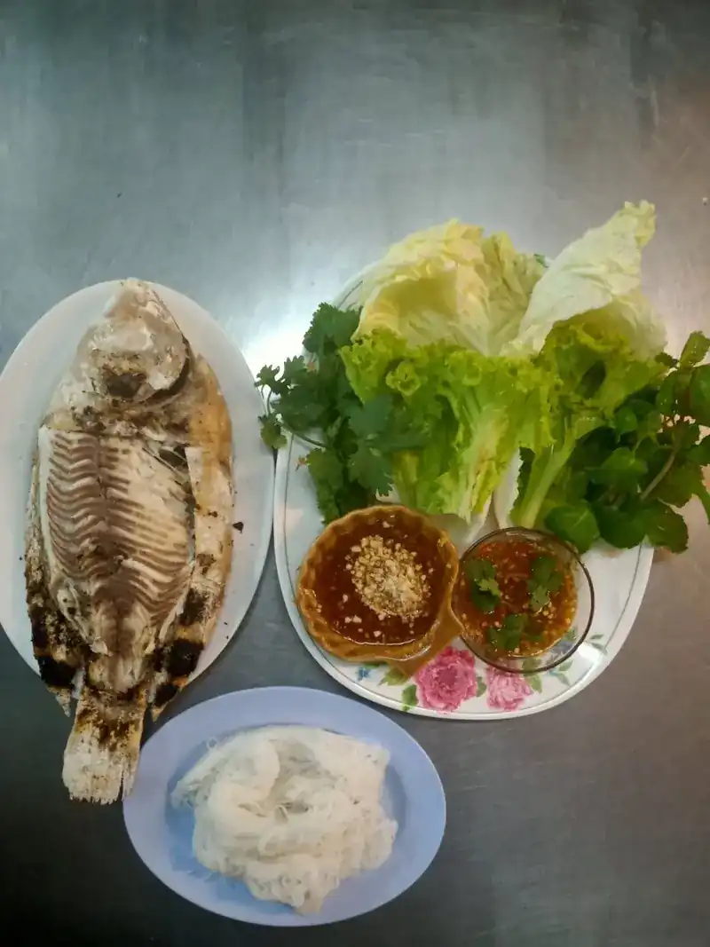 Grilled whole fish with lettuce, herbs and two dipping sauces