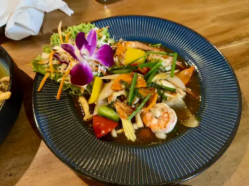 Prawns stir-fried with peppers, baby corn and spring onion in a dark sauce