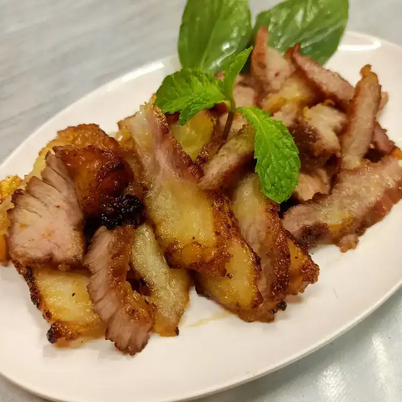 Sliced grilled pork with fresh herbs