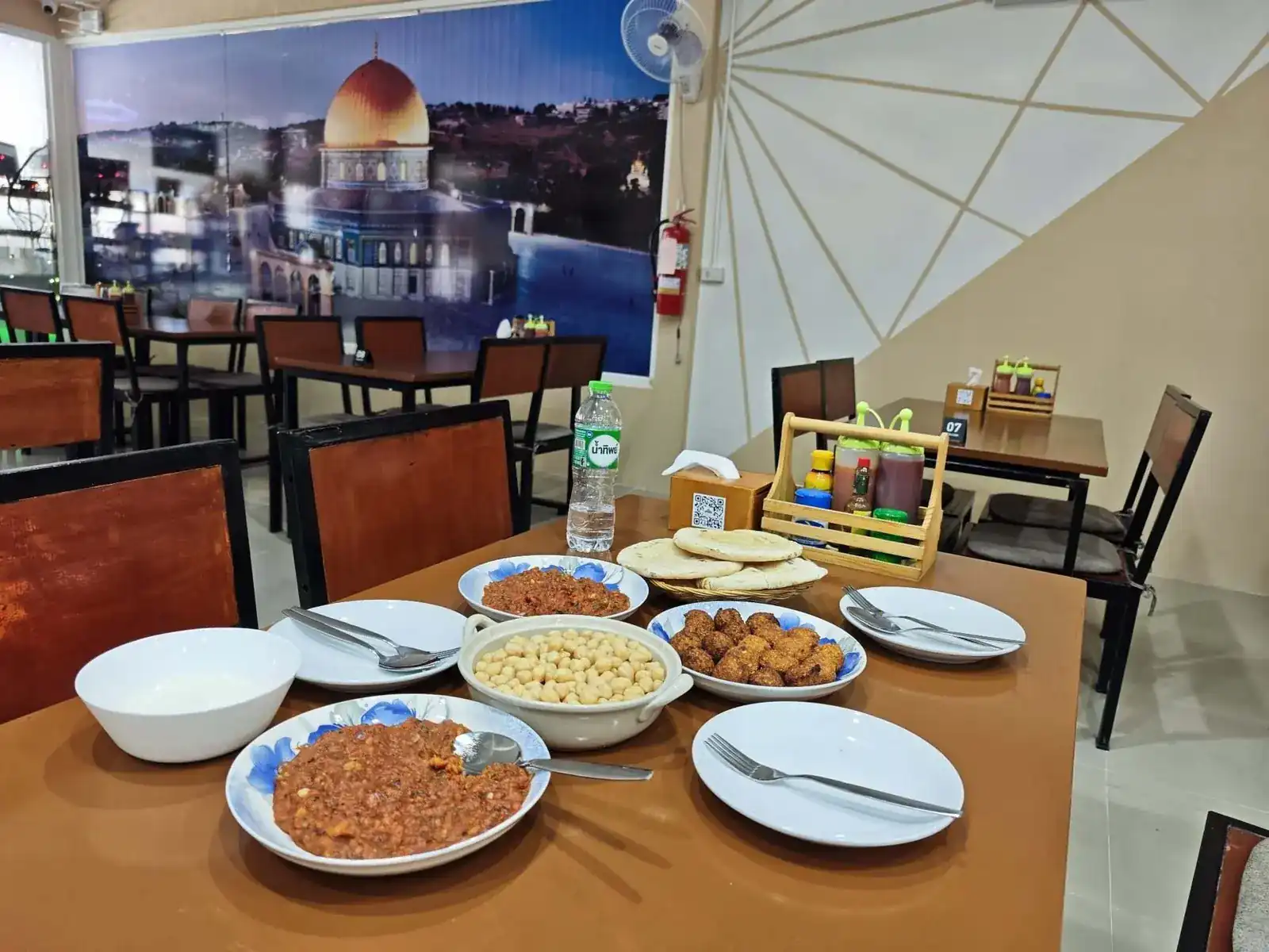 The dining room, with the Dome of the Rock across the back wall and a breakfast spread on the table