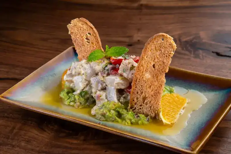 Mahi mahi ceviche with avocado, orange and toasted bread