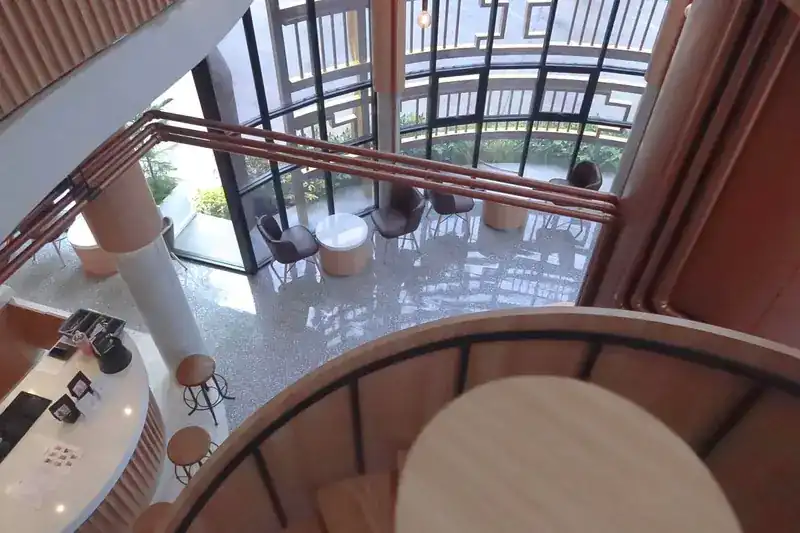 Looking down from the stairs at the bar and the glass wall