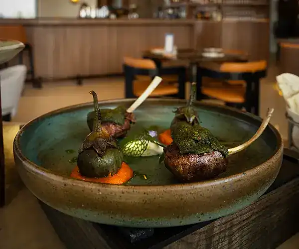 A main course in a stoneware bowl, served in the dining room