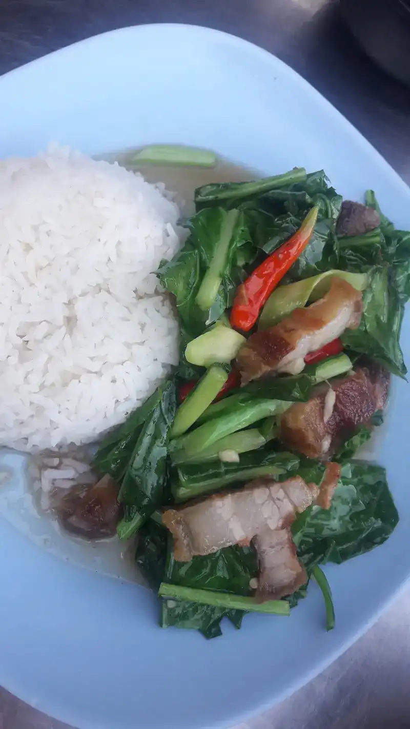 Crispy pork with Chinese kale and chilli beside a mound of rice