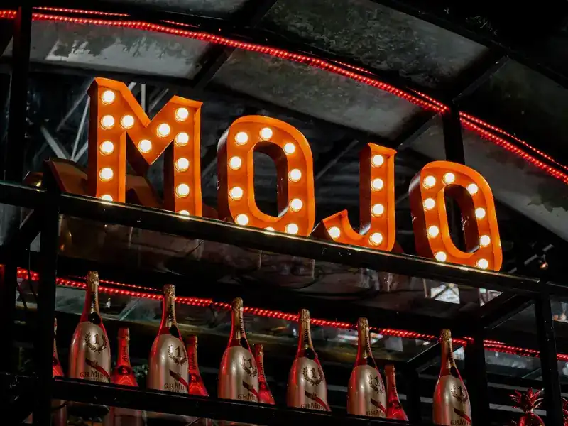 The MOJO letters lit with bulbs above the bar