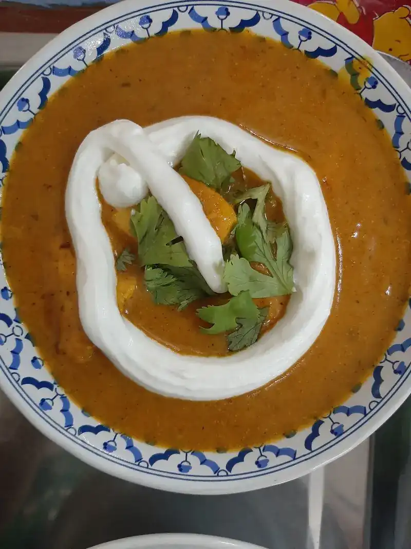 A curry finished with a swirl of cream and coriander