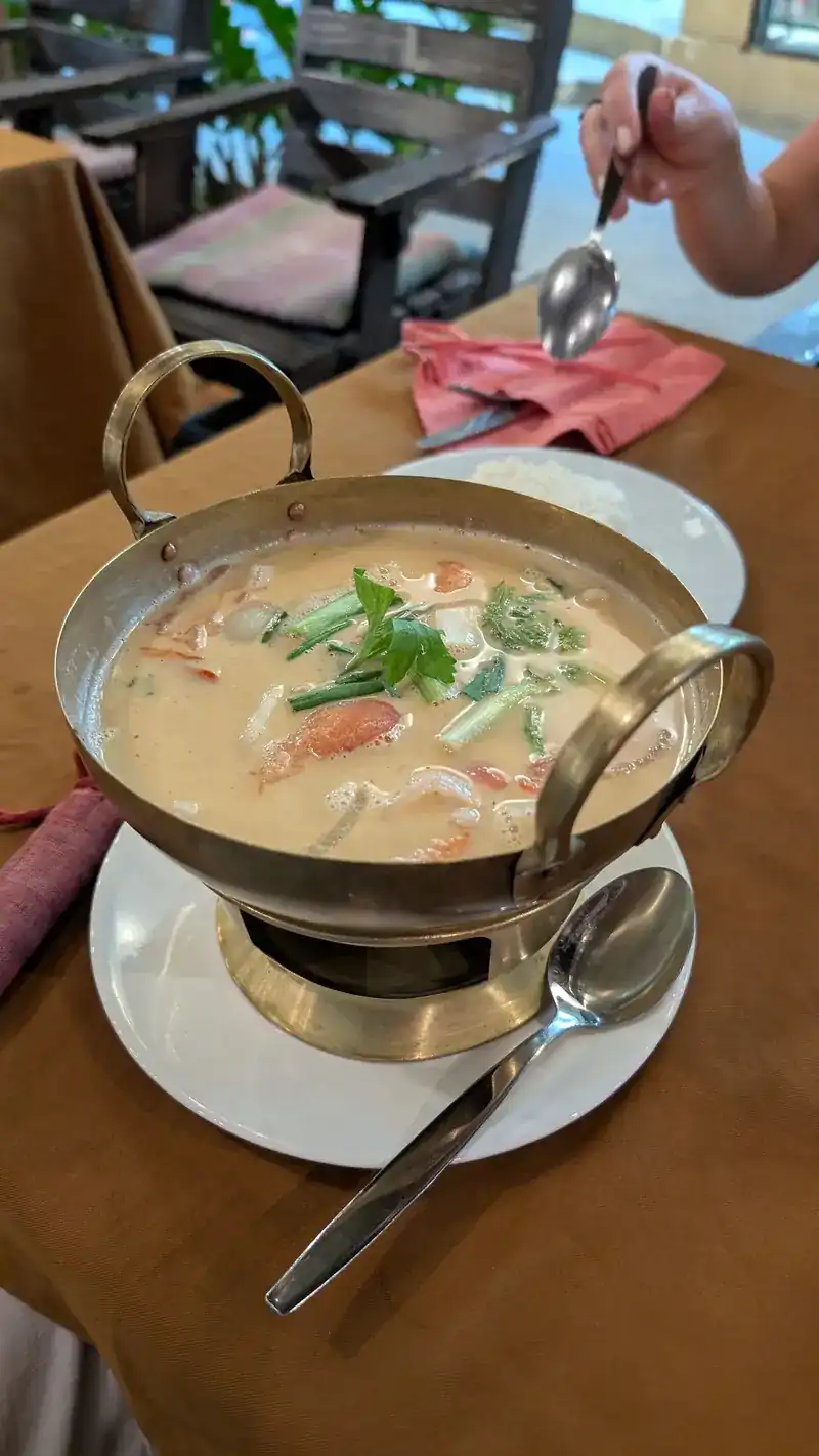 Creamy tom yam in a hot pot over a burner