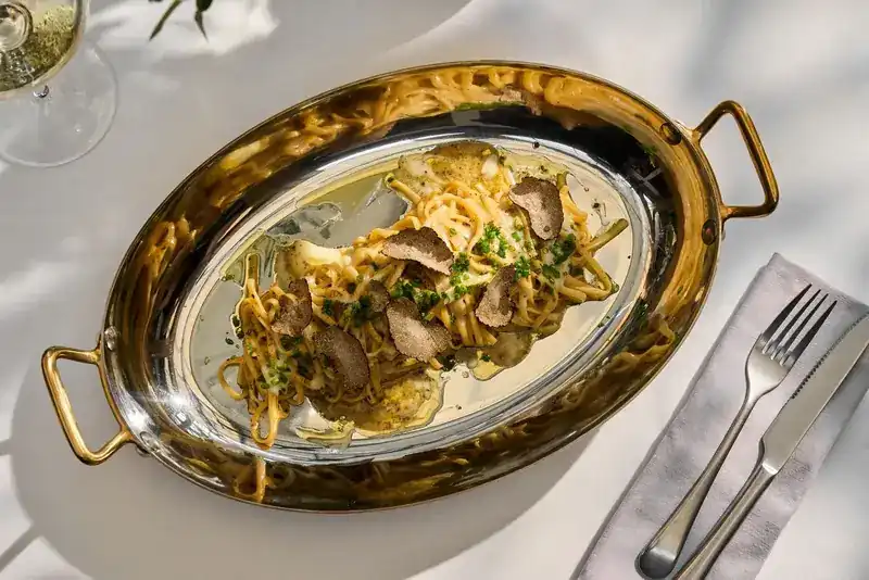 Pasta with sliced truffle served in a copper pan