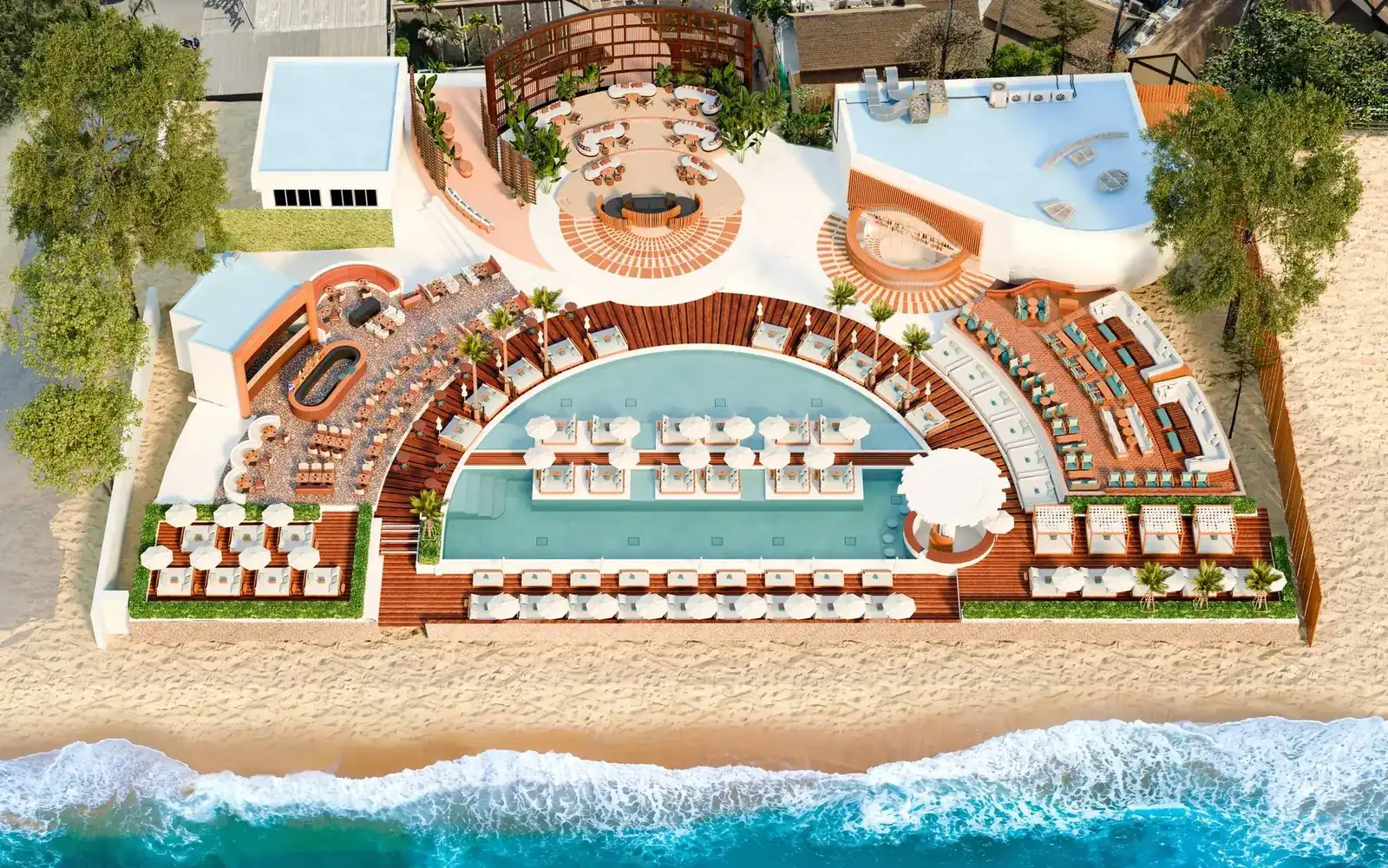 Barra Cuda Beach Club from above: a half-moon pool, day beds and cabanas on the sand at the edge of the sea