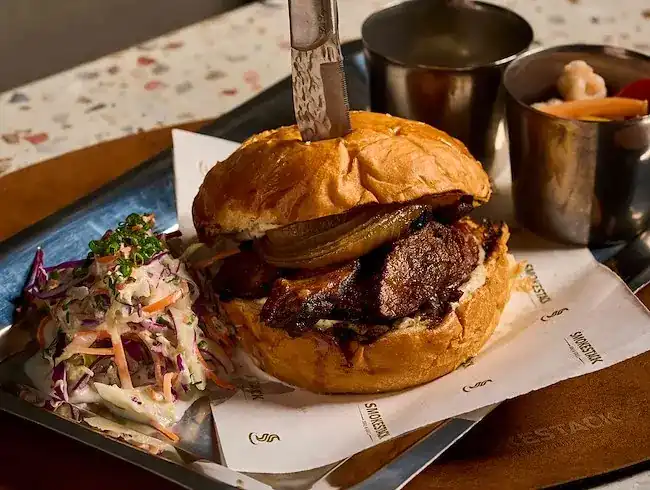 Beef short rib burger with slaw and pickles