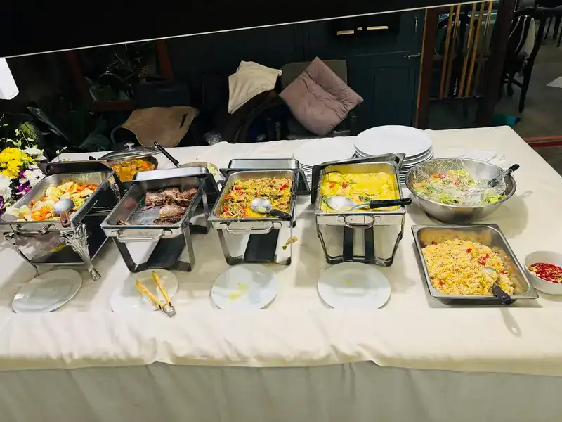 Buffet trays of food set out on a long table for a party