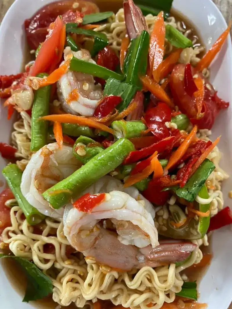 Noodles tossed with prawns, long beans, tomato and chilli