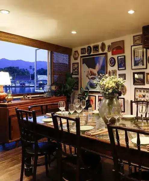 Private dining table by a window looking out to the water and hills