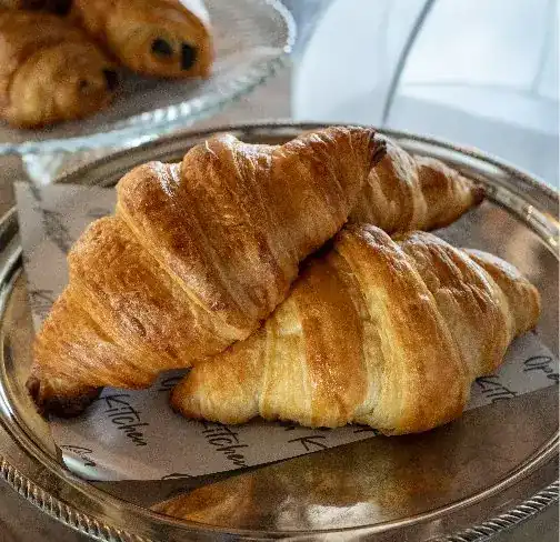 Butter croissants on a silver tray