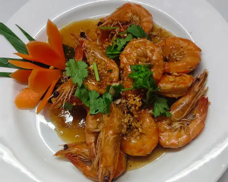 Prawns in a glossy brown sauce with garlic and coriander