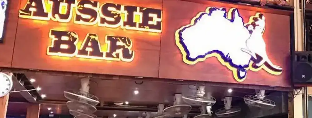 The lit Aussie Bar sign with the map of Australia and a kangaroo, above the bar on Bangla Road