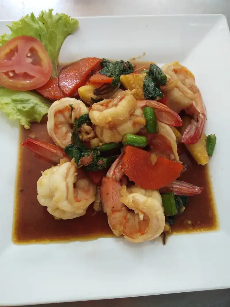 Prawns stir-fried with vegetables on a white plate