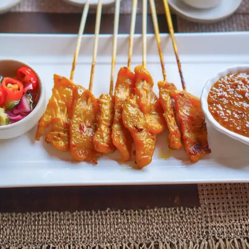 Satay skewers with peanut sauce and a cucumber relish